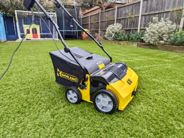 Garland 502E electric lawn sweeper in use on synthetic grass - before and after result
