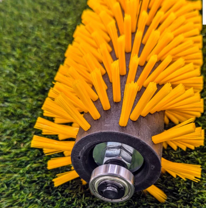 Close-up of a brush  502E roller with yellow bristles on a grass background